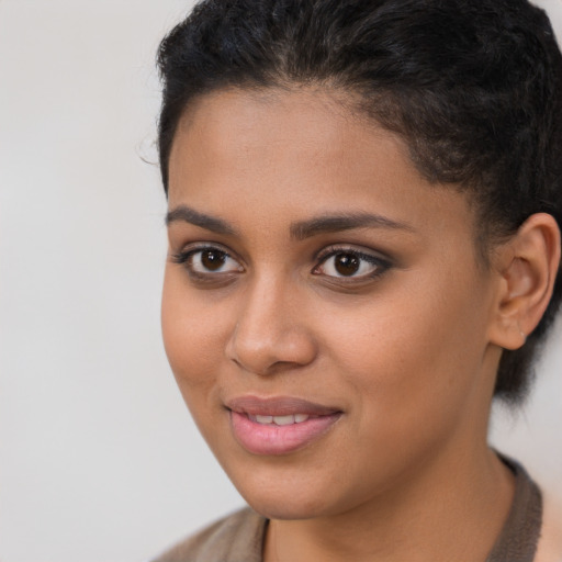 Joyful latino young-adult female with short  brown hair and brown eyes