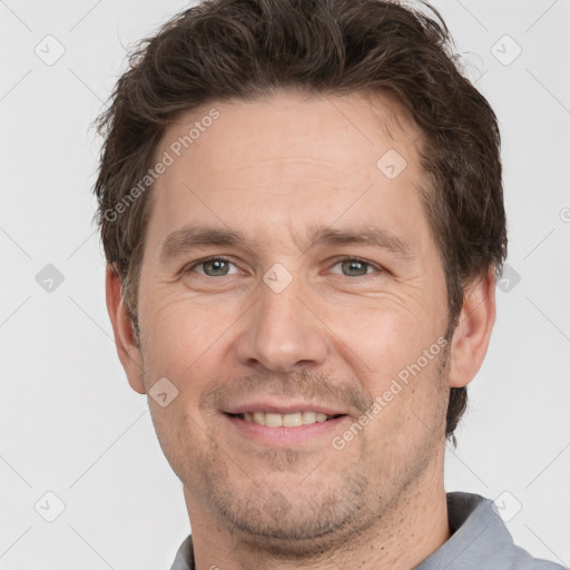 Joyful white adult male with short  brown hair and grey eyes