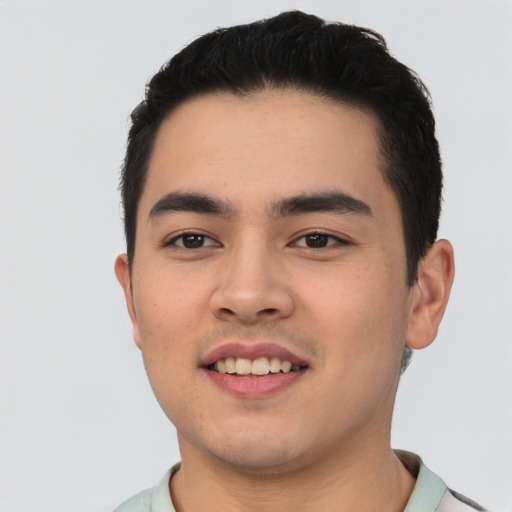 Joyful latino young-adult male with short  black hair and brown eyes