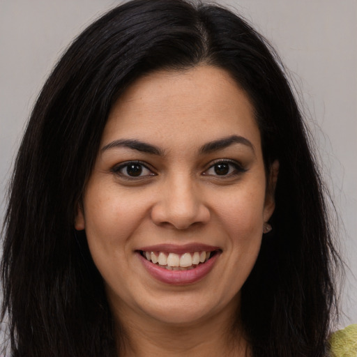 Joyful latino young-adult female with long  brown hair and brown eyes