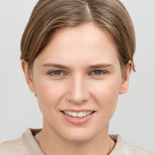 Joyful white young-adult female with short  brown hair and grey eyes