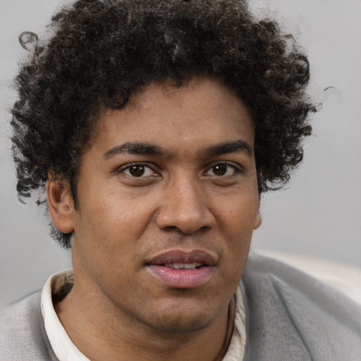 Joyful black adult male with short  brown hair and brown eyes