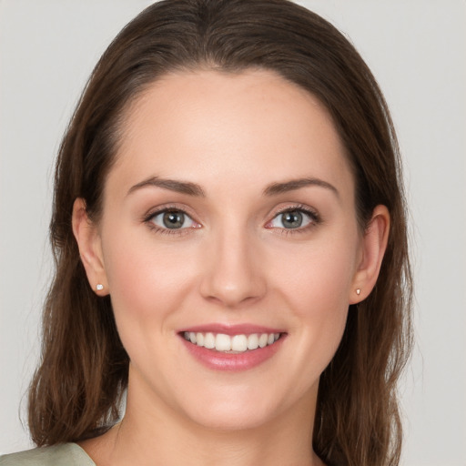 Joyful white young-adult female with long  brown hair and grey eyes