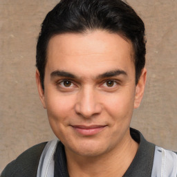 Joyful white young-adult male with short  black hair and brown eyes