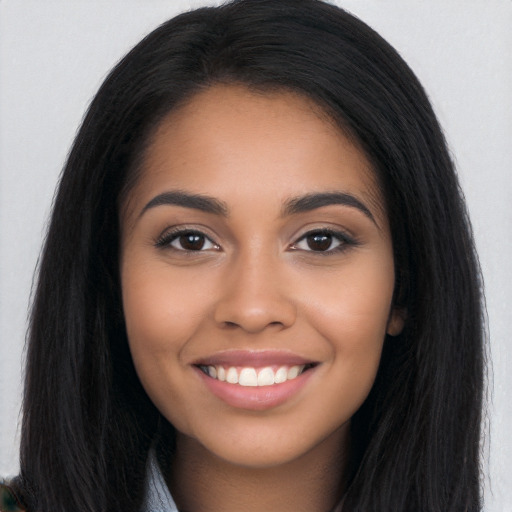 Joyful latino young-adult female with long  black hair and brown eyes