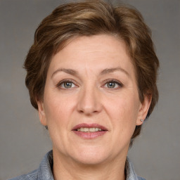 Joyful white adult female with medium  brown hair and grey eyes