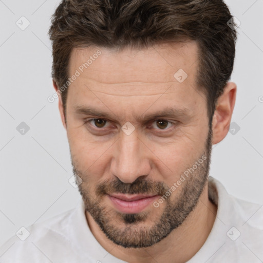 Joyful white adult male with short  brown hair and brown eyes