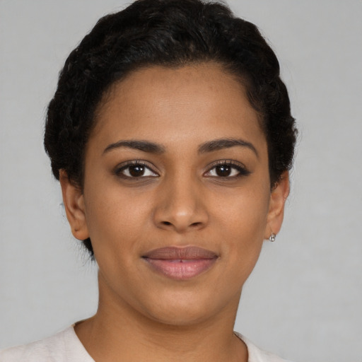 Joyful black young-adult female with short  brown hair and brown eyes