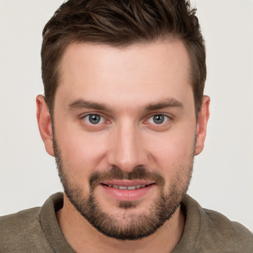 Joyful white young-adult male with short  brown hair and brown eyes