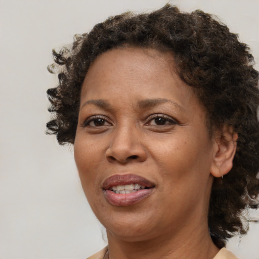 Joyful black young-adult female with medium  brown hair and brown eyes