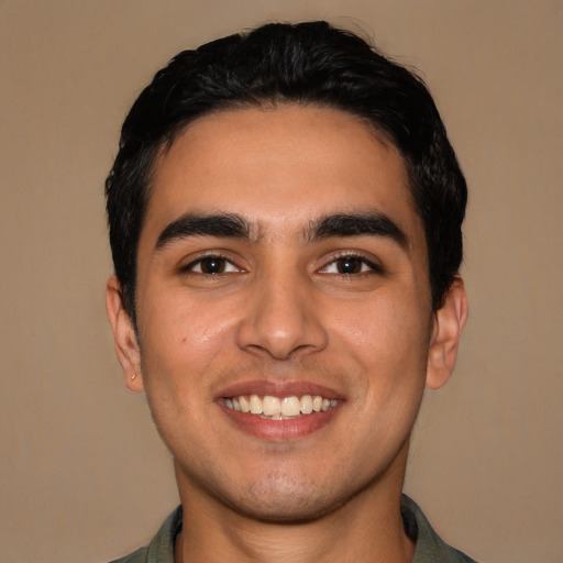 Joyful latino young-adult male with short  black hair and brown eyes