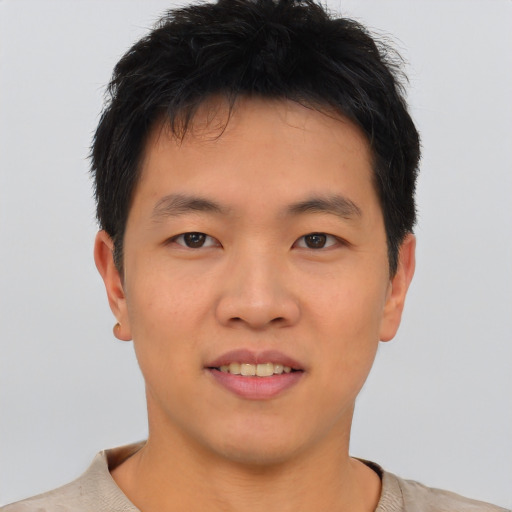 Joyful asian young-adult male with short  brown hair and brown eyes