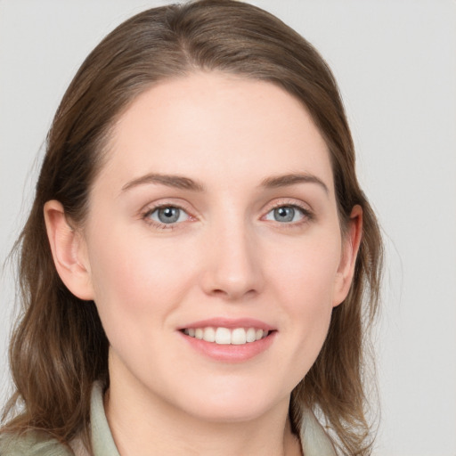 Joyful white young-adult female with medium  brown hair and blue eyes