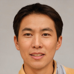 Joyful asian young-adult male with short  brown hair and brown eyes