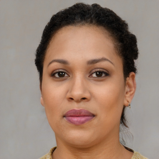 Joyful black young-adult female with short  brown hair and brown eyes
