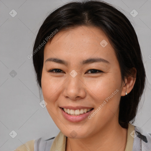 Joyful asian young-adult female with medium  brown hair and brown eyes