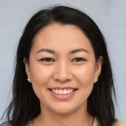 Joyful asian young-adult female with long  brown hair and brown eyes