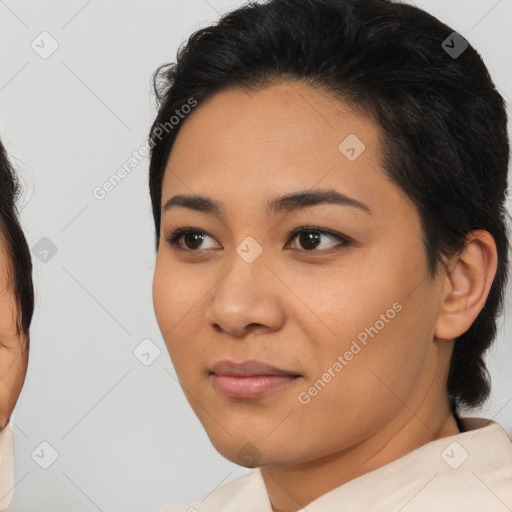 Joyful latino young-adult female with medium  brown hair and brown eyes