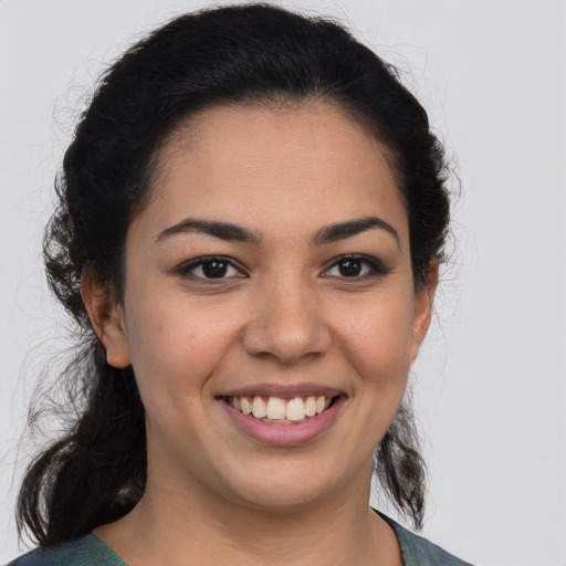 Joyful latino young-adult female with medium  brown hair and brown eyes