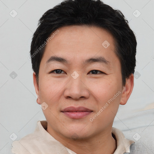 Joyful asian young-adult male with short  brown hair and brown eyes