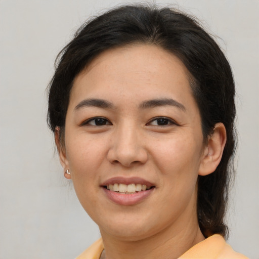 Joyful asian young-adult female with medium  brown hair and brown eyes