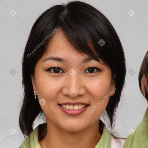 Joyful asian young-adult female with medium  brown hair and brown eyes