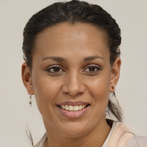 Joyful black young-adult female with short  brown hair and brown eyes