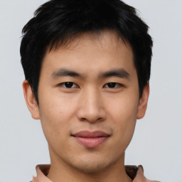 Joyful asian young-adult male with short  black hair and brown eyes