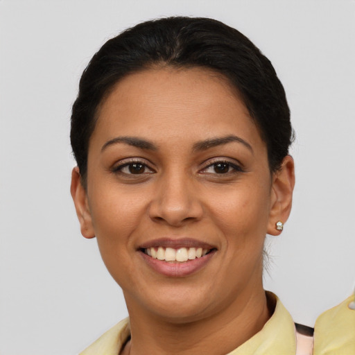 Joyful latino young-adult female with short  brown hair and brown eyes