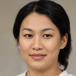 Joyful asian young-adult female with medium  brown hair and brown eyes