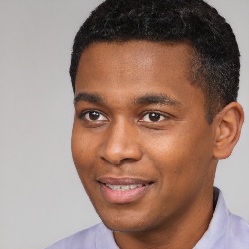 Joyful black young-adult male with short  black hair and brown eyes