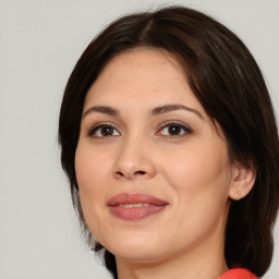 Joyful white adult female with medium  brown hair and brown eyes