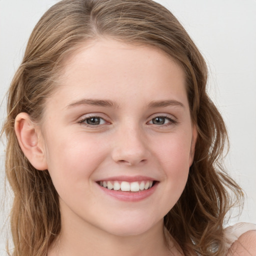 Joyful white child female with medium  brown hair and grey eyes