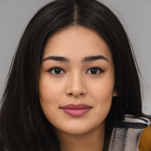 Joyful asian young-adult female with long  black hair and brown eyes