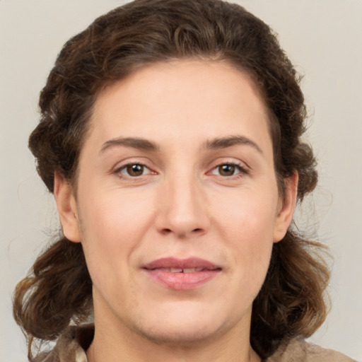 Joyful white young-adult female with medium  brown hair and green eyes