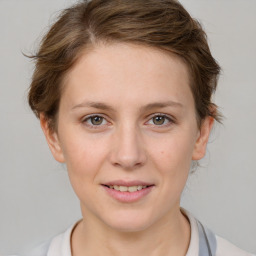 Joyful white young-adult female with medium  brown hair and grey eyes