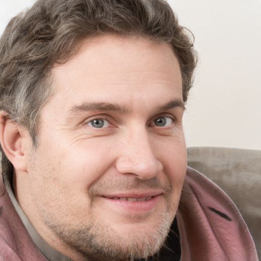 Joyful white adult male with short  brown hair and grey eyes