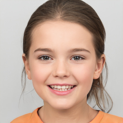 Joyful white child female with medium  brown hair and brown eyes