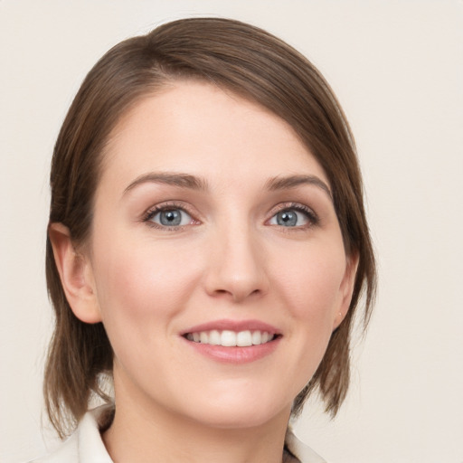 Joyful white young-adult female with medium  brown hair and blue eyes