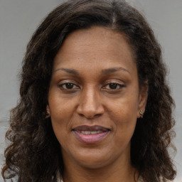 Joyful white adult female with long  brown hair and brown eyes