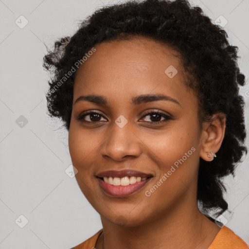 Joyful black young-adult female with long  black hair and brown eyes