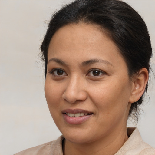 Joyful latino adult female with medium  brown hair and brown eyes