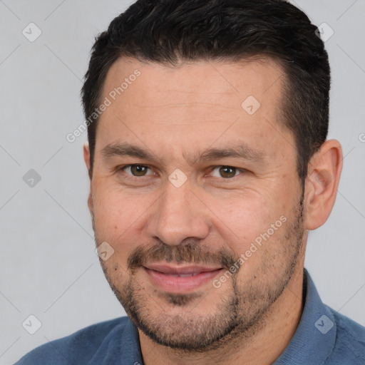 Joyful white adult male with short  brown hair and brown eyes