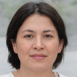 Joyful white adult female with medium  brown hair and brown eyes