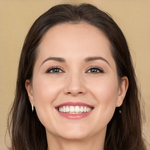 Joyful white young-adult female with long  brown hair and brown eyes