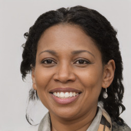 Joyful black adult female with medium  brown hair and brown eyes