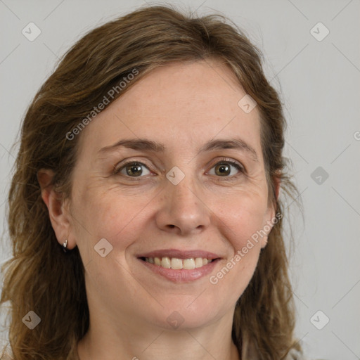 Joyful white adult female with long  brown hair and grey eyes