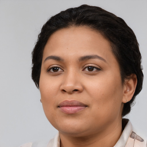 Joyful latino young-adult female with short  black hair and brown eyes