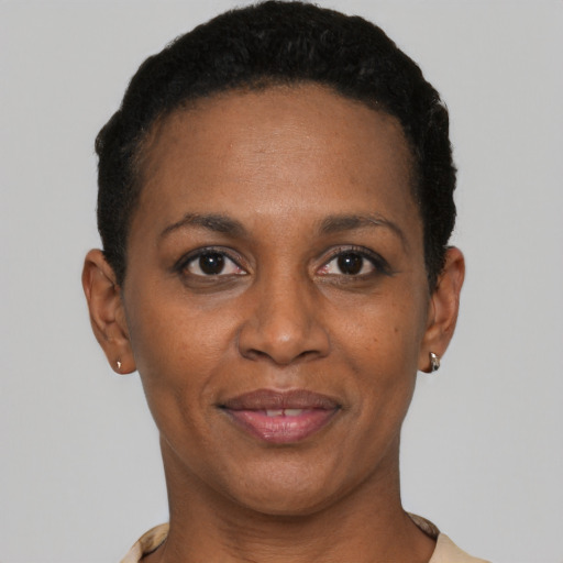 Joyful black adult female with short  brown hair and brown eyes
