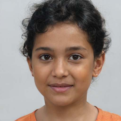 Joyful latino child female with short  brown hair and brown eyes